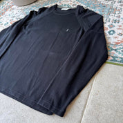 Yves Saint Laurent black knitted sweatshirt with embroidered YSL logo and slim fit.