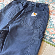 Carhartt WIP navy shorts with logo patch and durable cotton material.