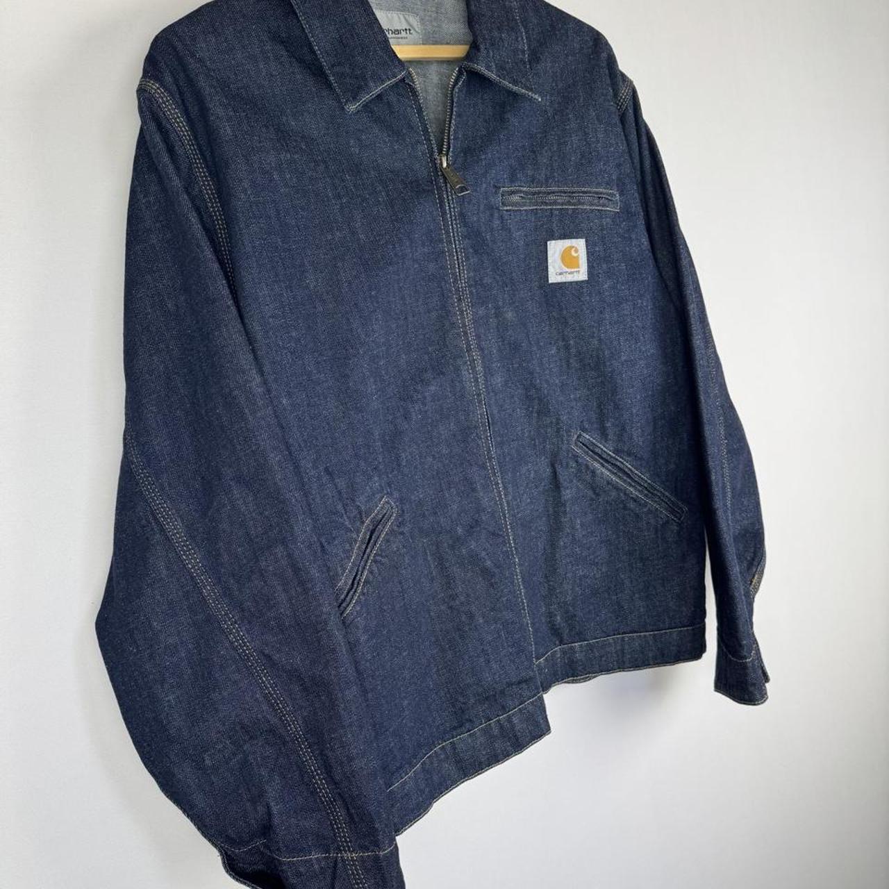 Carhartt WIP blue denim jacket with logo patch and classic design details.
