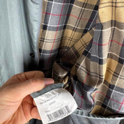 Barbour blue lightweight Beaufort jacket with subtle marks and classic logo detail.