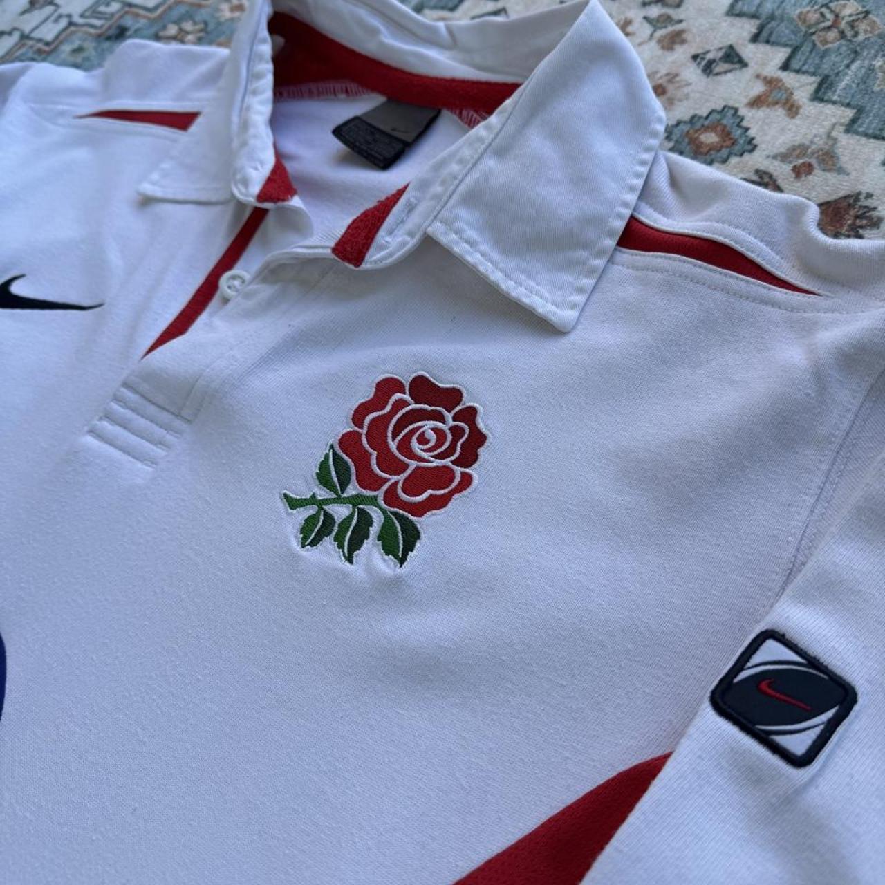 Nike long sleeve polo shirt in navy blue with embroidered England Rugby logo.