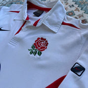 Nike long sleeve polo shirt in navy blue with embroidered England Rugby logo.