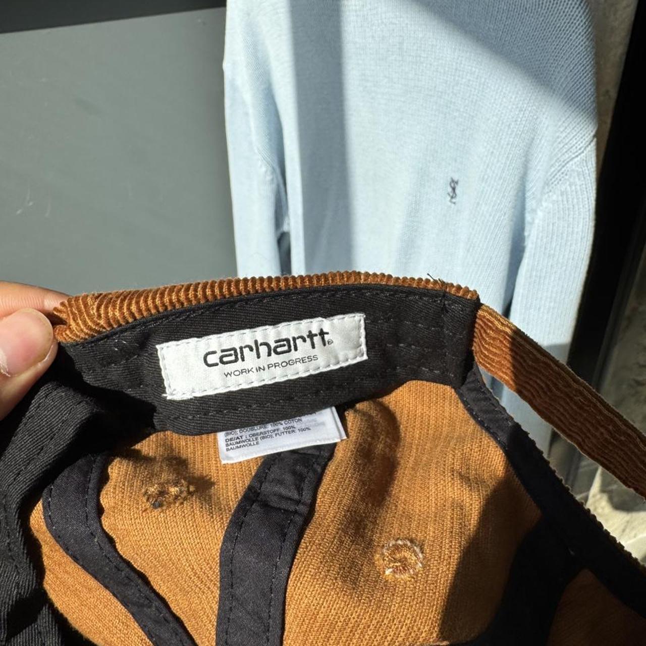 Carhartt WIP hat brown corduroy with embroidered logo and rugged design.