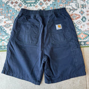 Carhartt WIP navy shorts with logo patch and durable cotton material.