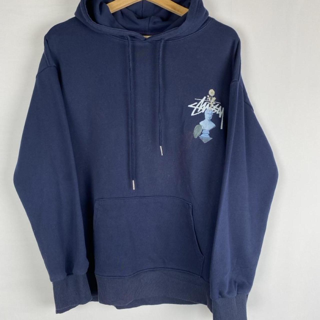 Stüssy black hoodie with stone statue graphic and logo print.