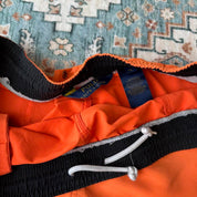 Polo Ralph Lauren orange swim trunks with iconic embroidered logo and lightweight fabric.