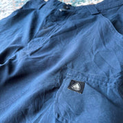 Nike ACG cargo shorts olive green with multiple pockets and logo patch detail.