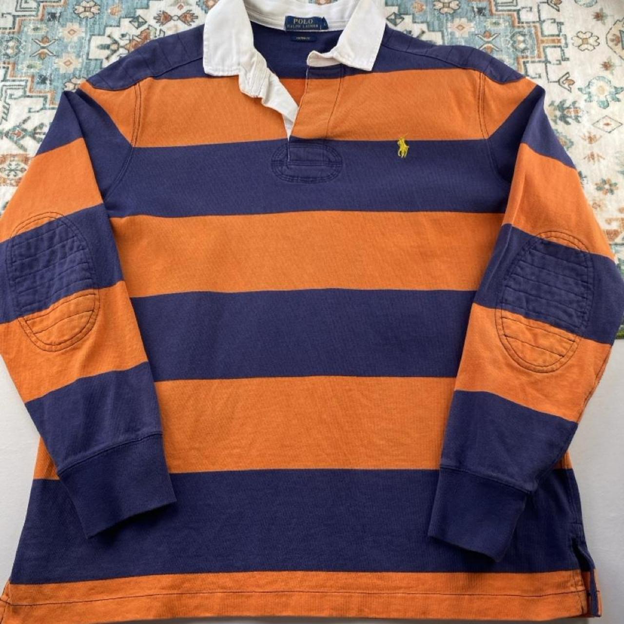 Polo Ralph Lauren navy and orange rugby polo shirt with thick stripes and embroidered logo.