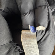 Canada Goose black parka jacket with logo patch and fur-lined hood.