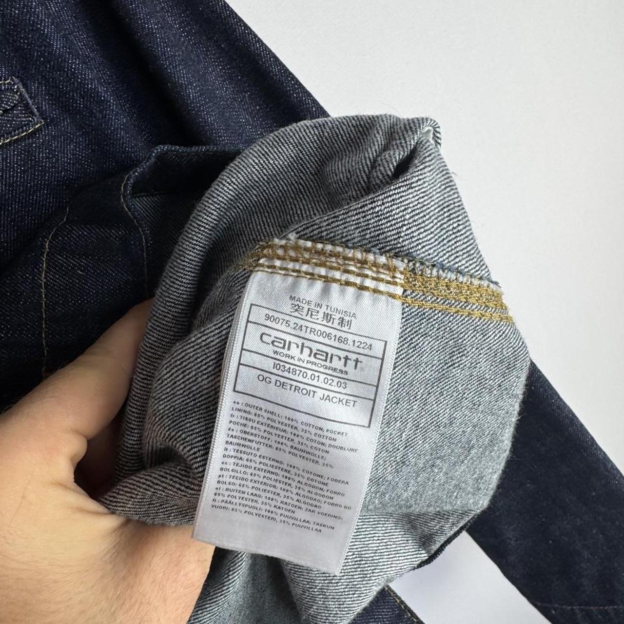 Carhartt WIP blue denim jacket with logo patch and classic design details.