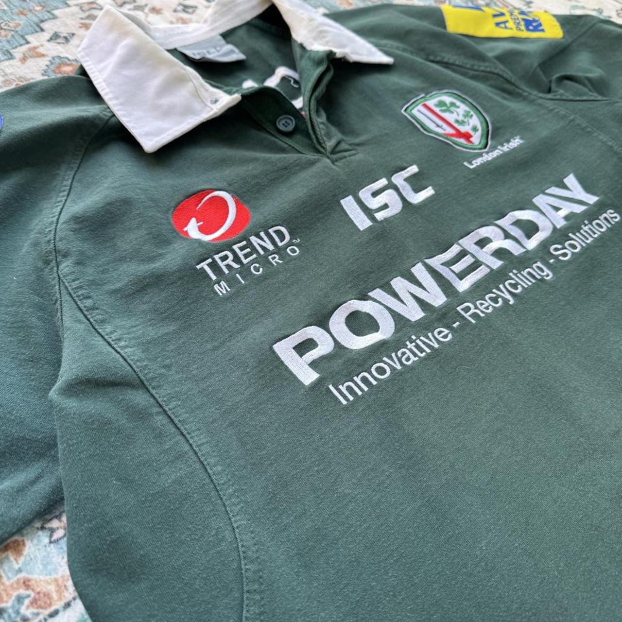 ISC green rugby polo shirt with embroidered London Irish logo and slim fit.