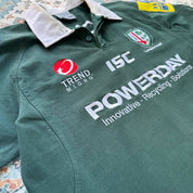 ISC green rugby polo shirt with embroidered London Irish logo and slim fit.