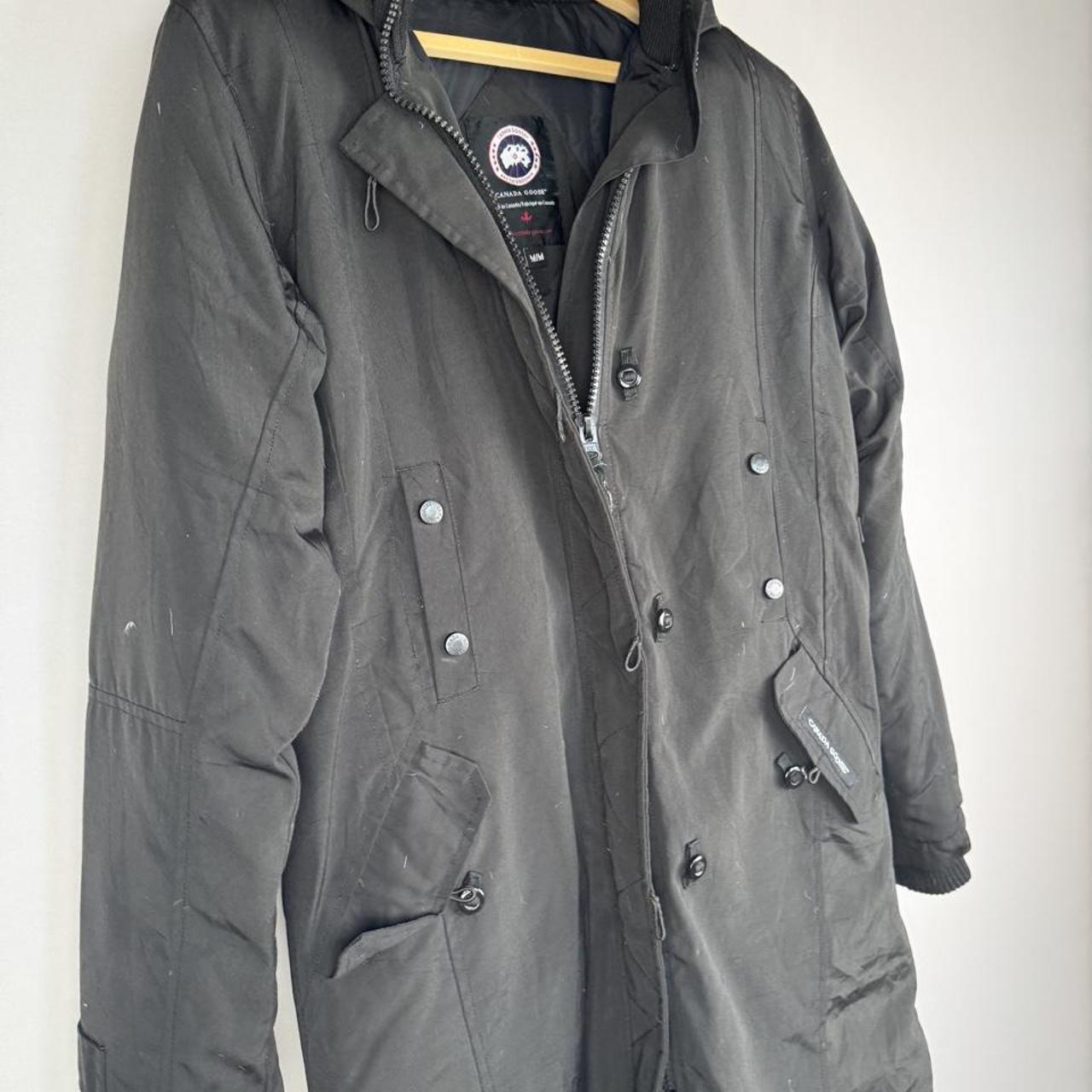 Canada Goose black parka jacket, medium size, features logo patch and sleek design.