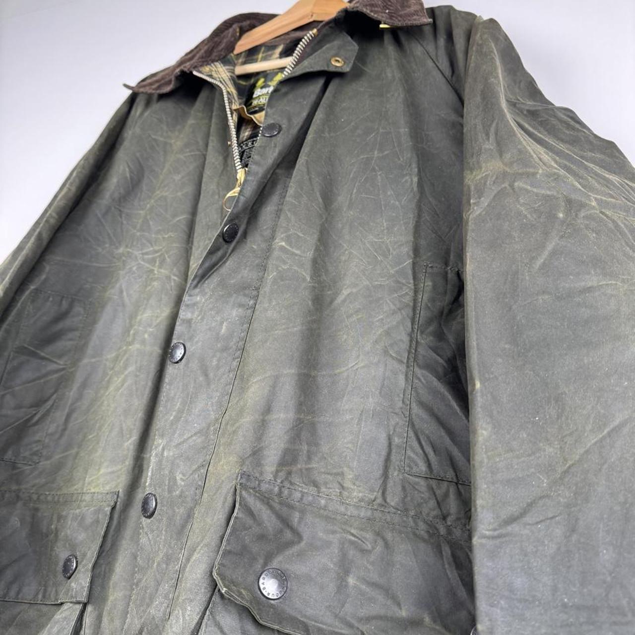 Barbour green waxed Beaufort jacket with attached hood and classic logo detail.