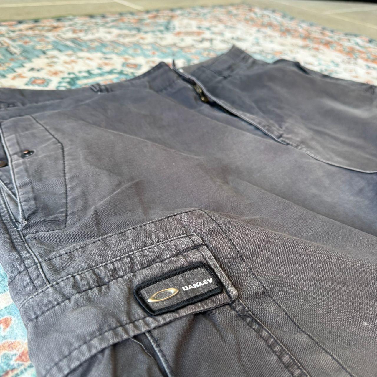 Oakley black cargo shorts with embroidered logo and tactical pockets.