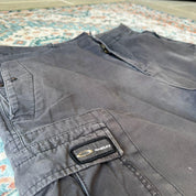 Oakley black cargo shorts with embroidered logo and tactical pockets.