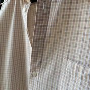 Yves Saint Laurent cream short sleeve shirt with embroidered YSL logo and button details.