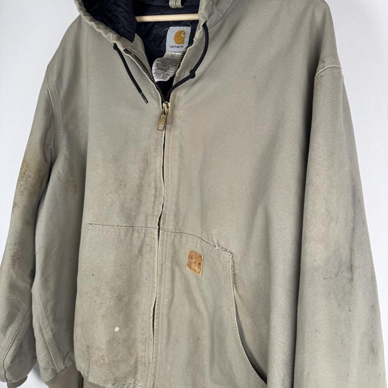 Carhartt active jacket, orange, oversized fit, visible logo, durable material.