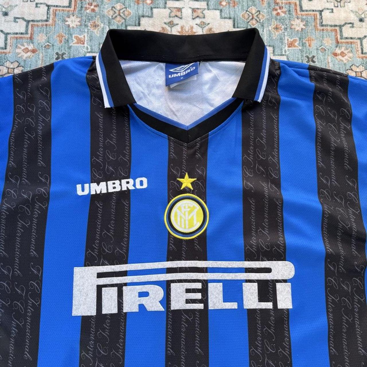 Umbro blue and navy striped home jersey with embroidered logo and vintage design.