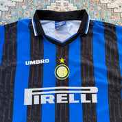Umbro blue and navy striped home jersey with embroidered logo and vintage design.