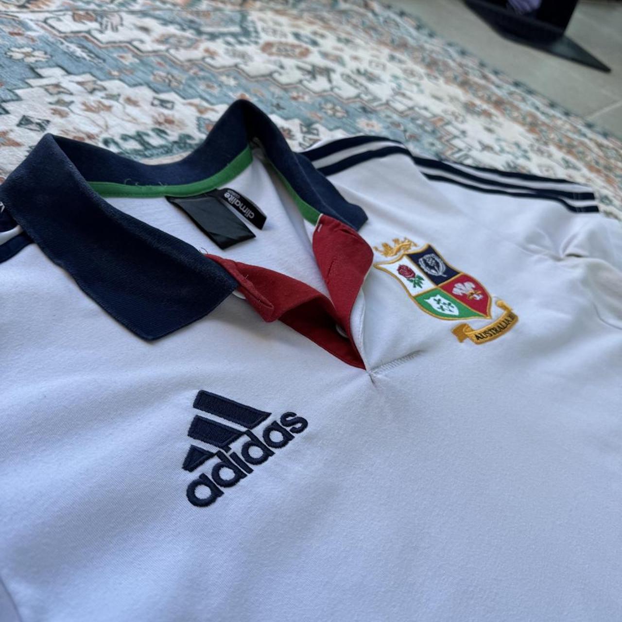 Adidas men's polo shirt red with British and Irish Lions logo and embroidered details.