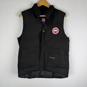 Canada Goose black puffer gilet with logo patch and quilted design.