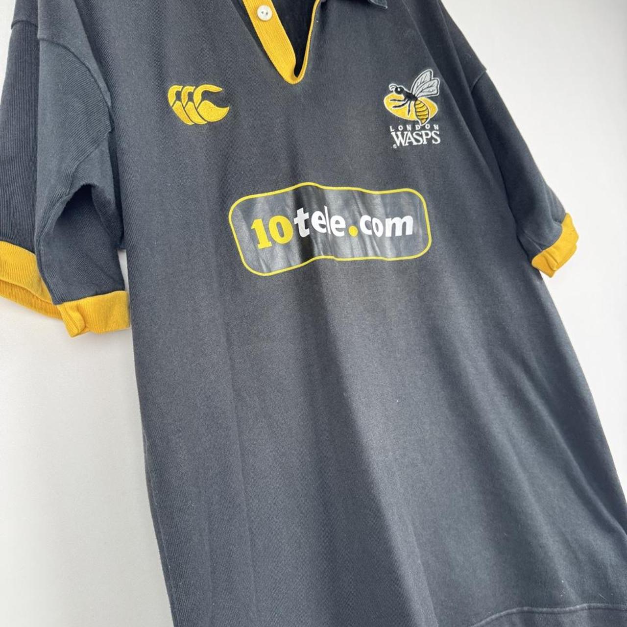 Canterbury men's rugby polo shirt, black and gold, featuring Wasps logo and classic design.