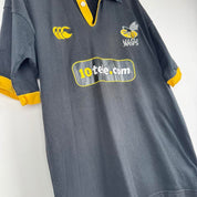 Canterbury men's rugby polo shirt, black and gold, featuring Wasps logo and classic design.