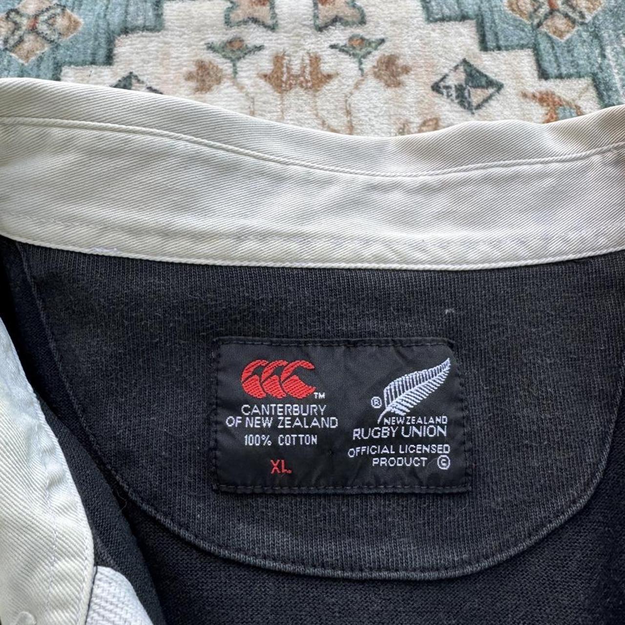 Canterbury men's polo shirt black with All Blacks logo and rugby pattern details.