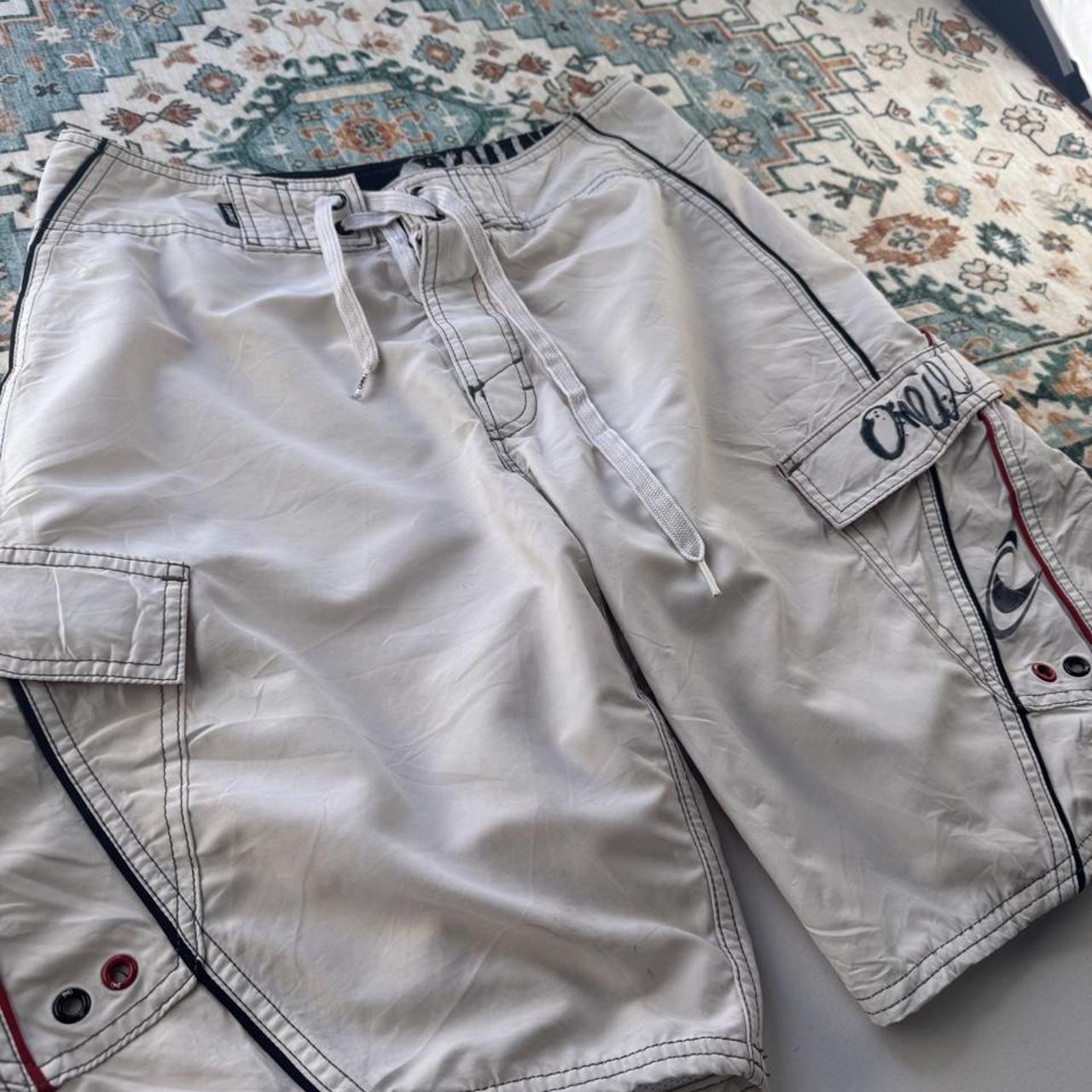 O'Neill cream board shorts with embroidered logo and relaxed baggy fit.