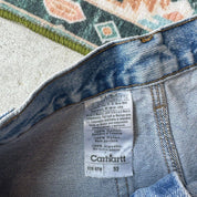 Carhartt denim baggy shorts blue with classic logo and carpenter pockets.