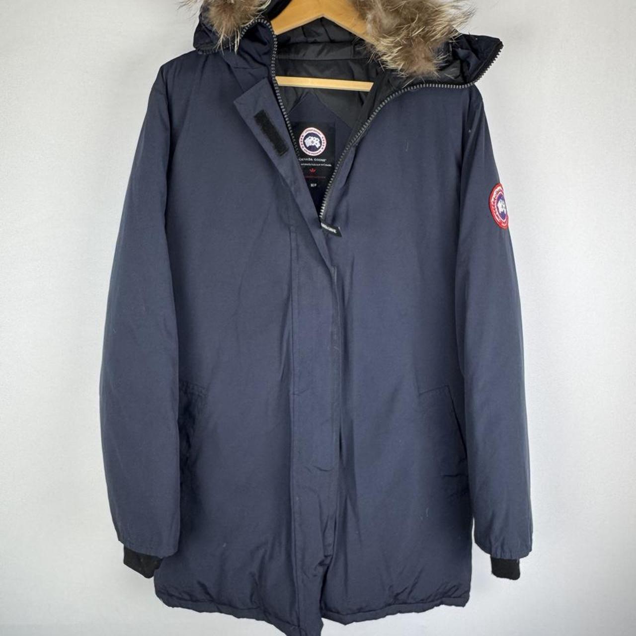 Canada Goose navy parka jacket with logo patch and fur-lined hood.