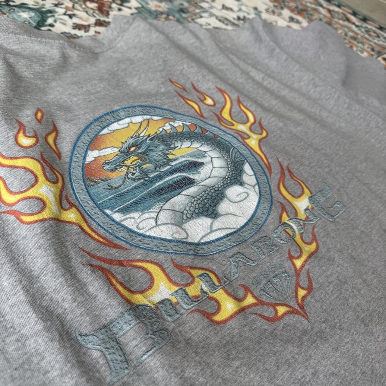 Billabong oversized graphic t-shirt blue with cream and green patterns, featuring pocket detail.