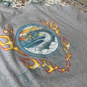 Billabong oversized graphic t-shirt blue with cream and green patterns, featuring pocket detail.