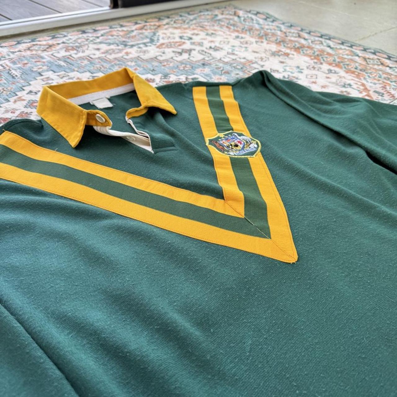 1990s Australia Wallabies rugby polo green with embroidered logo and classic collar.