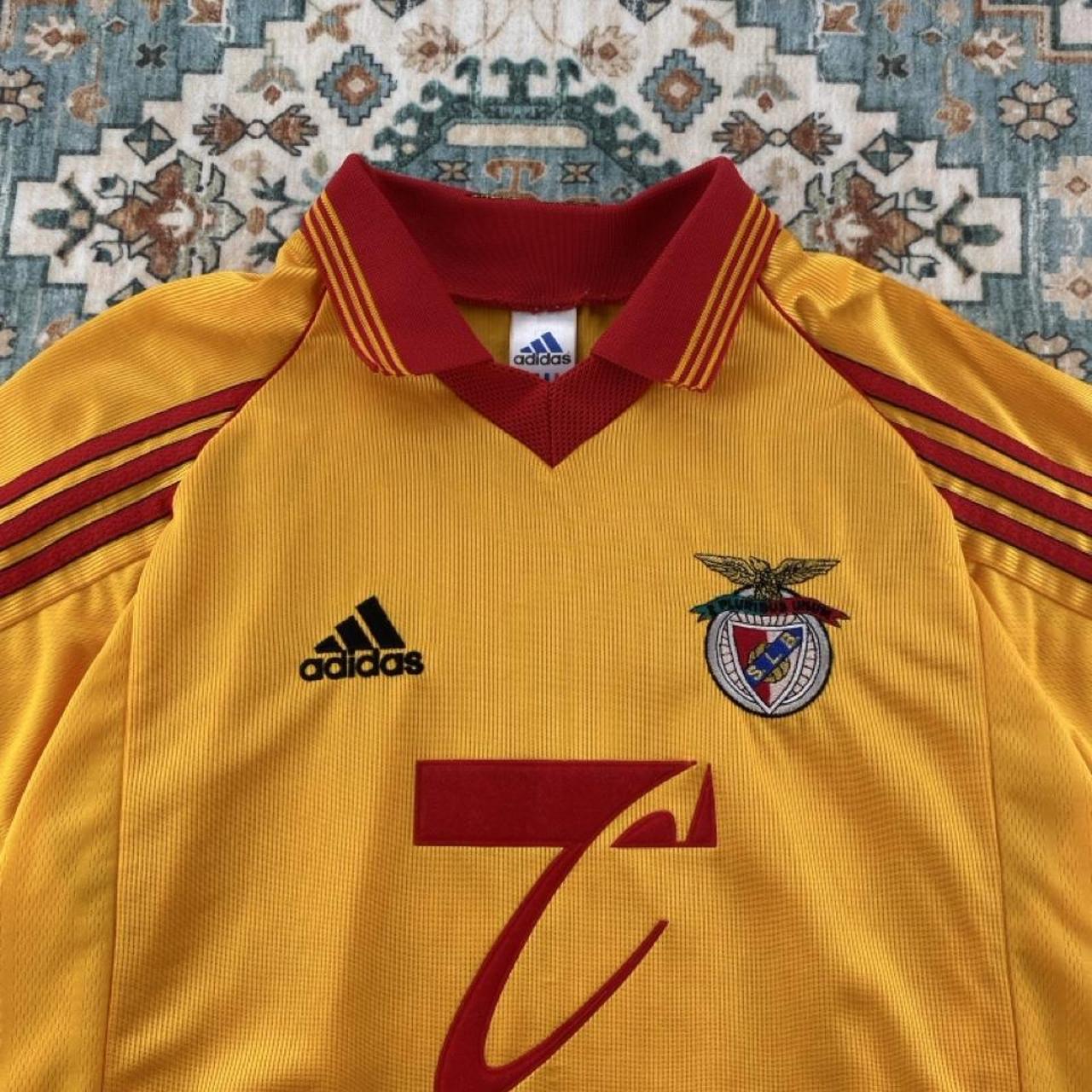 Adidas orange Benfica away jersey with embroidered logo and vintage design details.