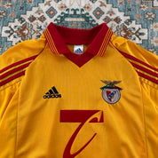 Adidas orange Benfica away jersey with embroidered logo and vintage design details.