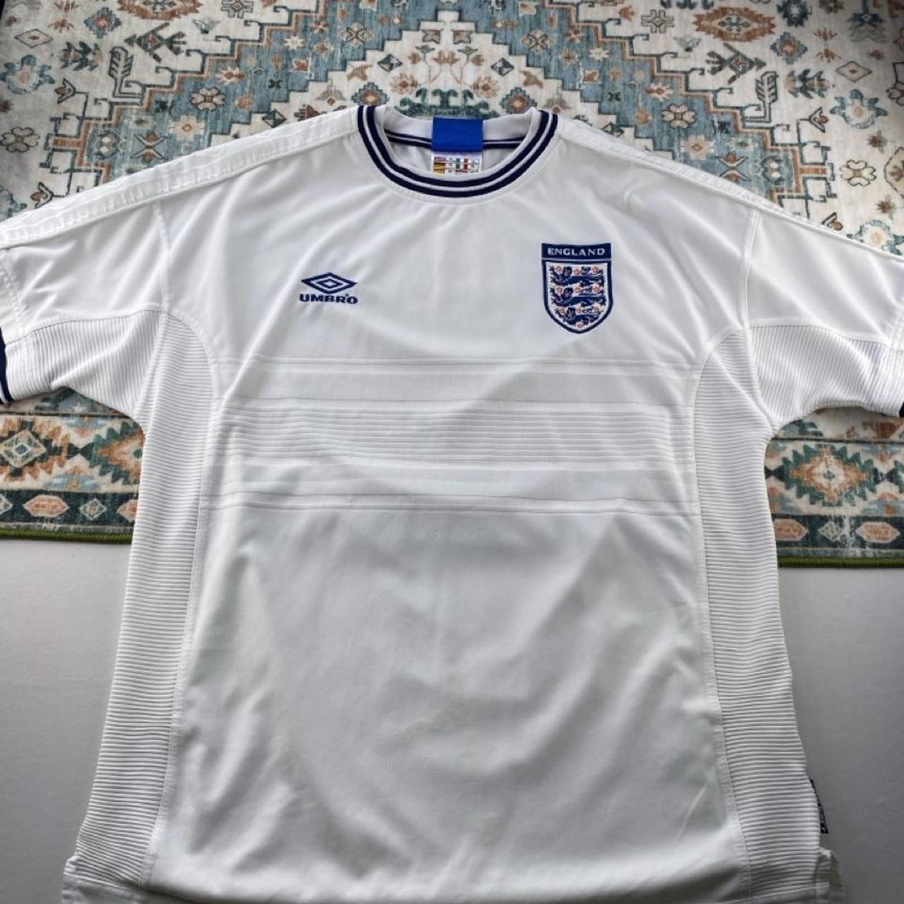 Umbro England home jersey, red with white logo and classic football design.