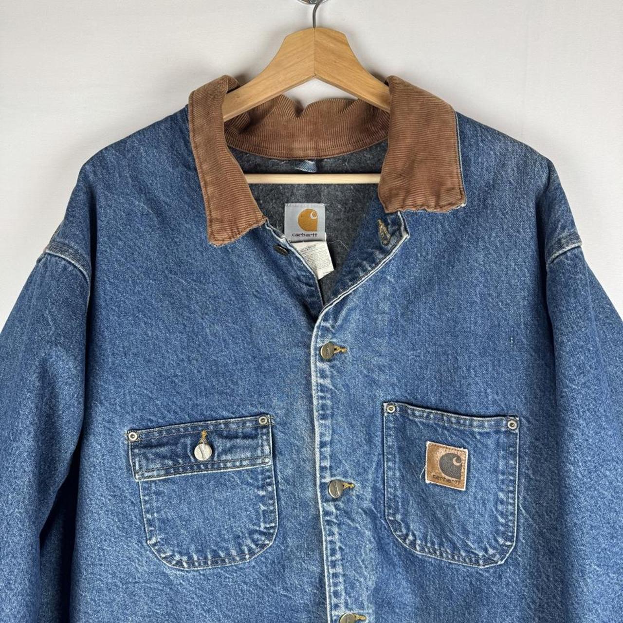 Carhartt denim chore jacket oversized 1990s style with classic logo and blue wash.