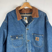 Carhartt denim chore jacket oversized 1990s style with classic logo and blue wash.