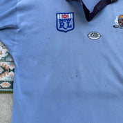 NSW Rugby League blue polo shirt with embroidered logo and vintage 1990s design.