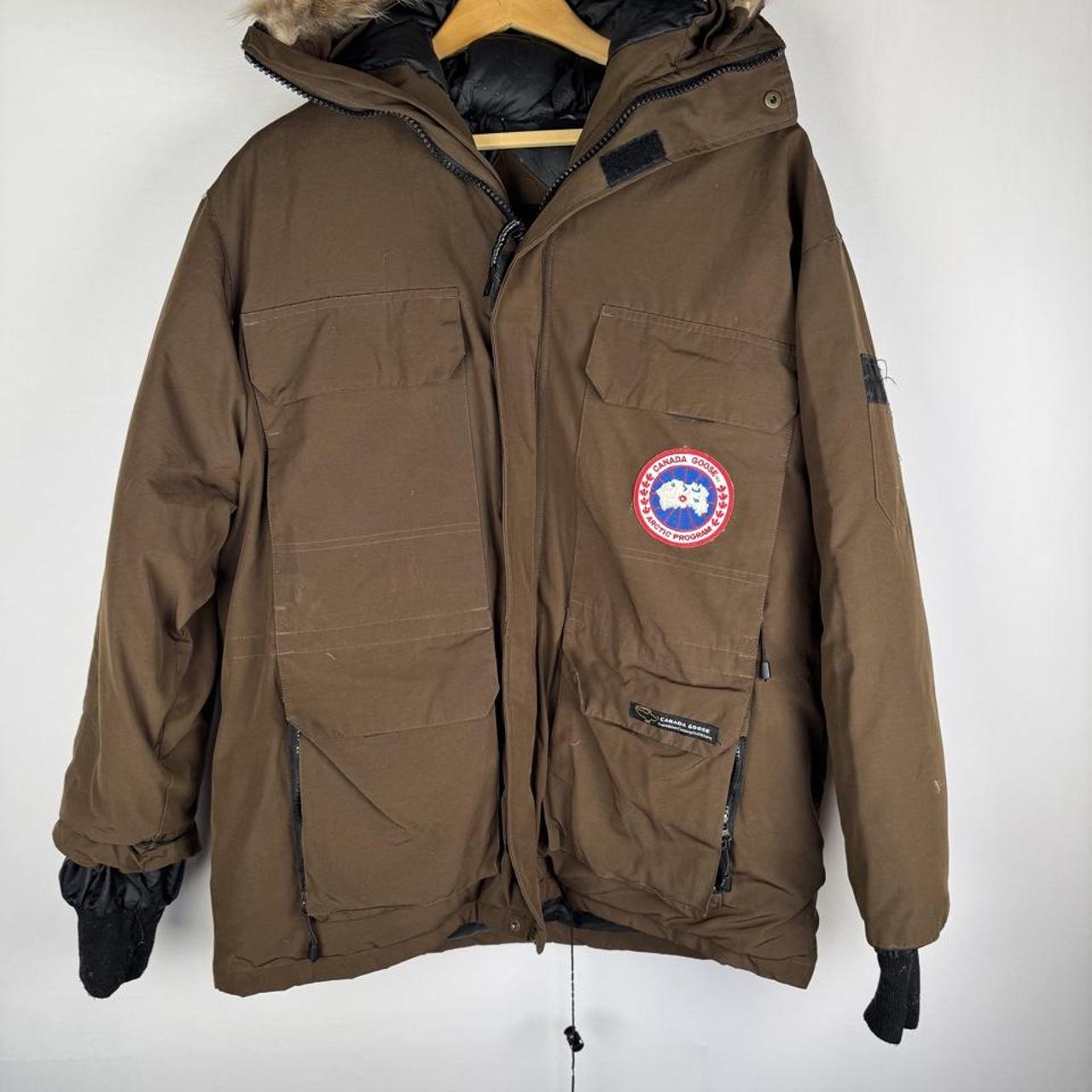 Canada Goose brown parka jacket with utility pockets and logo patch.