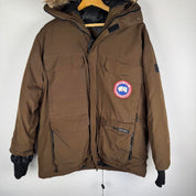 Canada Goose brown parka jacket with utility pockets and logo patch.