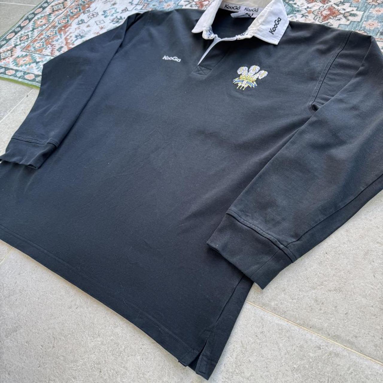 Kooga men's polo shirt in Prince of Wales pattern, featuring logo and regular fit.