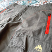 Nike ACG grey cargo shorts with multiple pockets and embroidered logo detail.