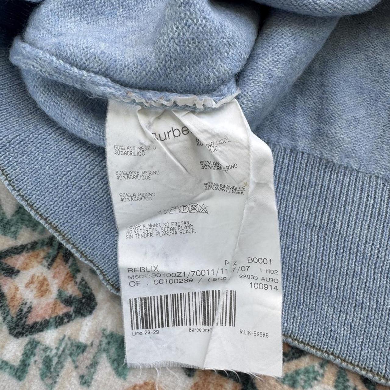 Burberry light blue knitted jumper featuring iconic check pattern and soft merino wool.