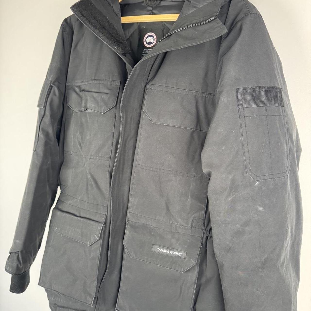 Canada Goose black parka jacket oversized fit with utility pockets and logo patch.