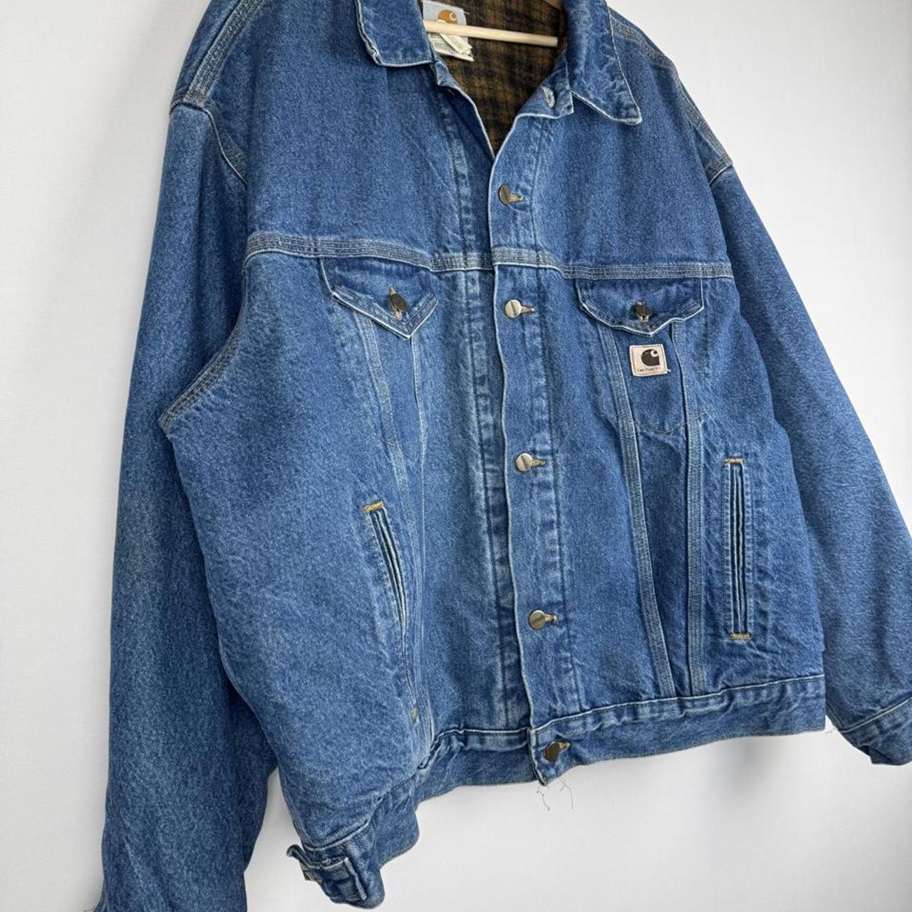 Carhartt denim trucker jacket 1990s style with classic logo and relaxed fit.
