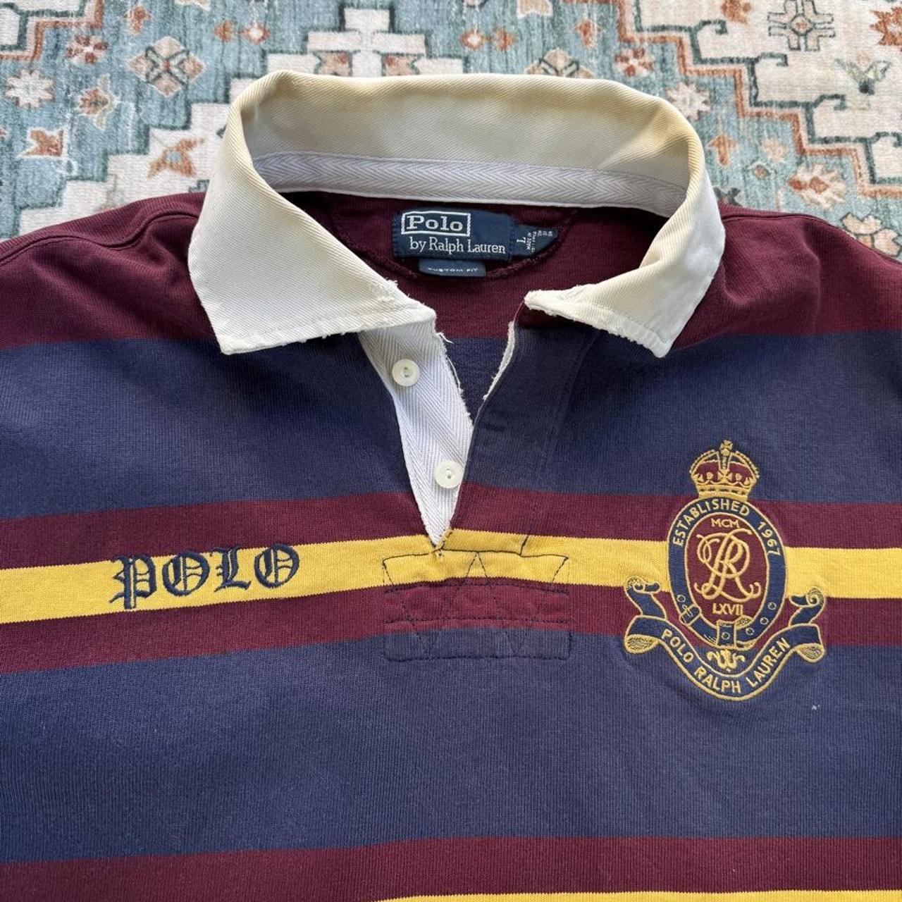 Polo Ralph Lauren burgundy and yellow short sleeve rugby polo with logo and collar details.