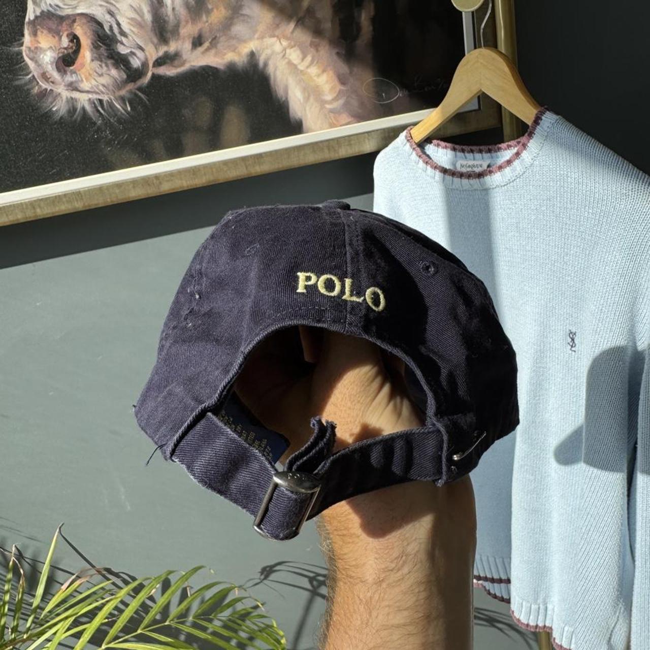 Polo Ralph Lauren navy cap with yellow embroidered logo and adjustable strap.